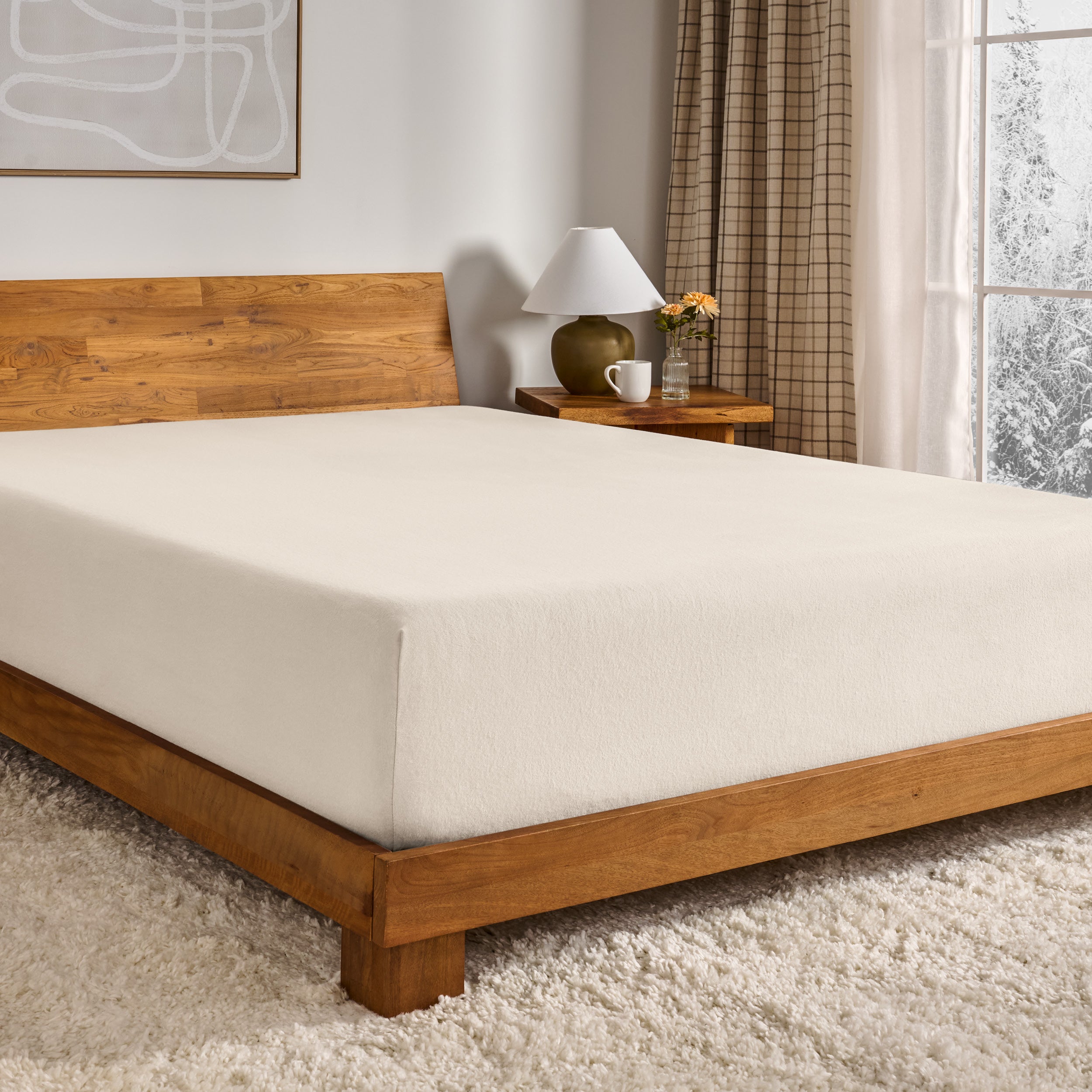 Sand fitted sheet on a wooden bed in a bedroom setting