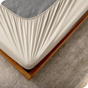 The corner of a box spring with a cover on it