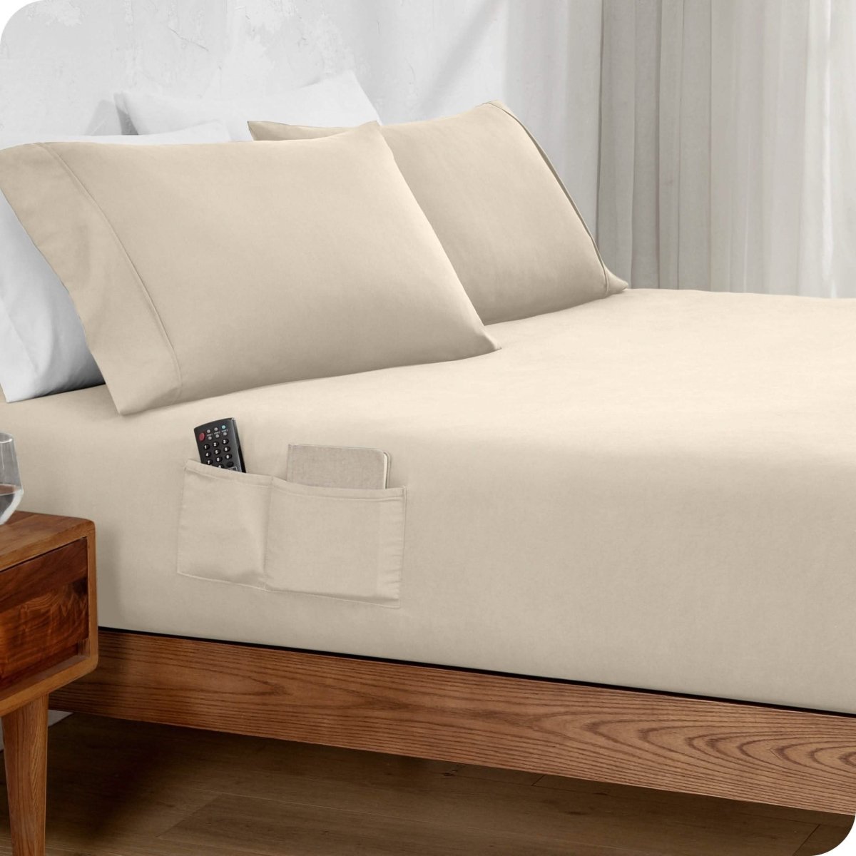 Bed made with a fitted sheet which has pockets on the side