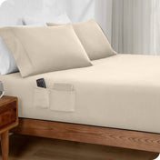 Bed made with a fitted sheet which has pockets on the side