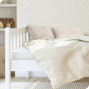 A toddler's bed with 2 microfiber pillowcases on pillows
