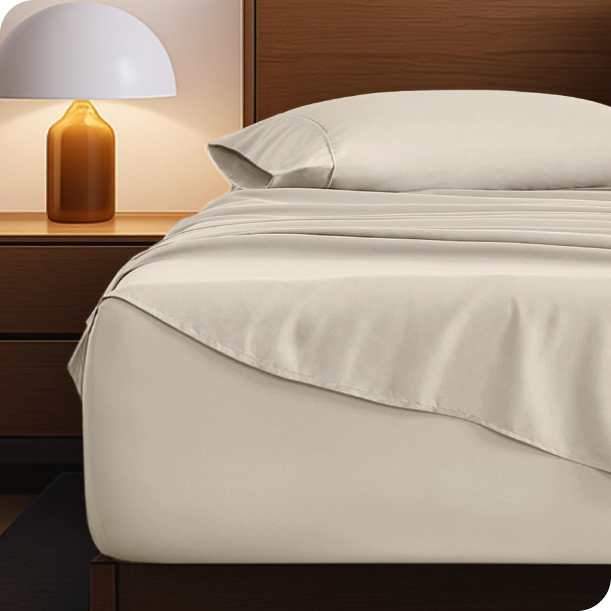 Microfiber bed sheets on a neatly made bed with a wooden headboard and nightstand.