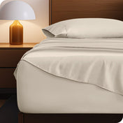 Microfiber bed sheets on a neatly made bed with a wooden headboard and nightstand.