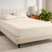 A bed made with a percale fitted sheet
