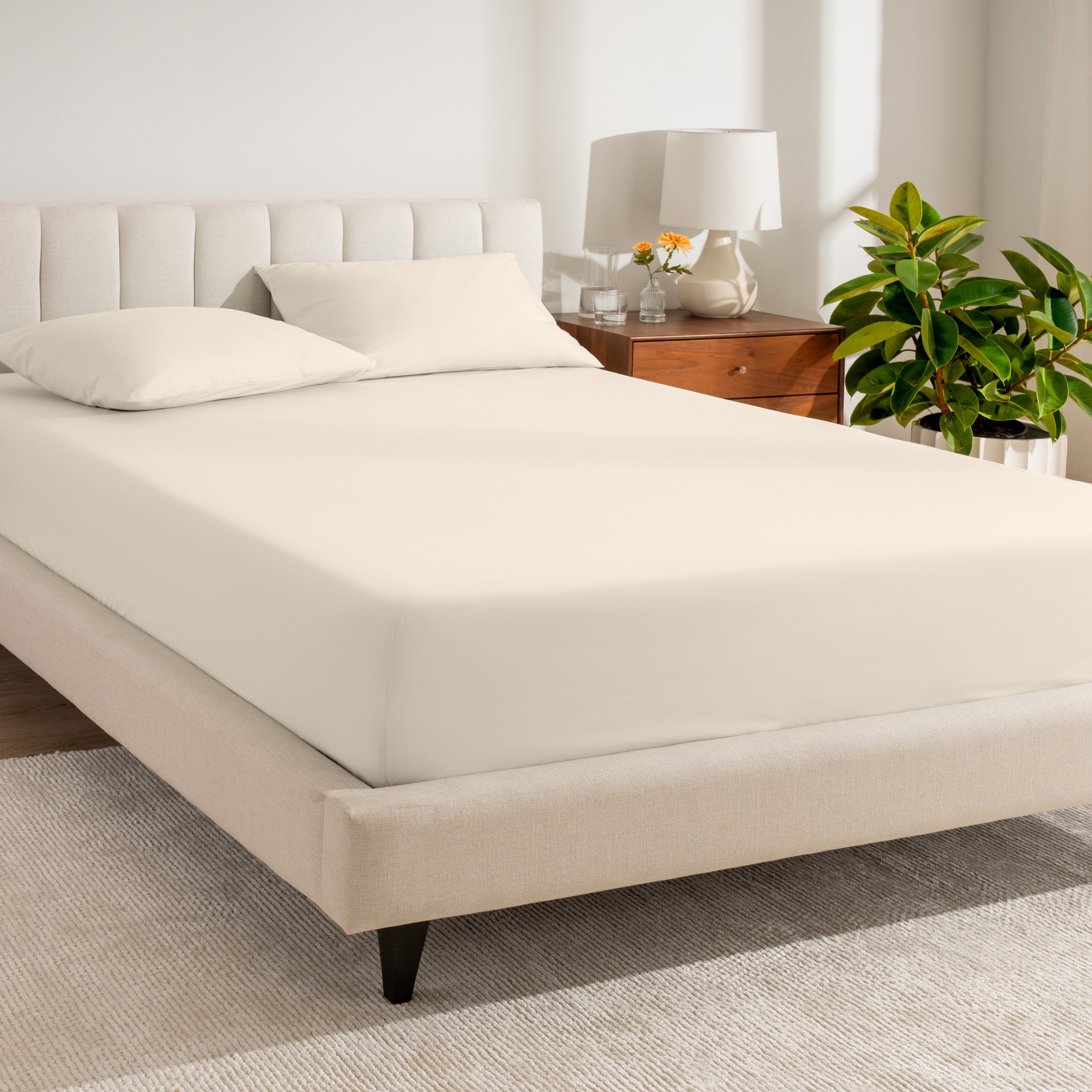 A bed made with a percale fitted sheet