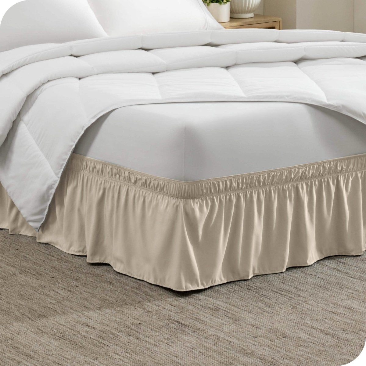 Corner of a bed with a polyester wrap around bed skirt on it
