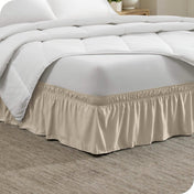 Corner of a bed with a polyester wrap around bed skirt on it