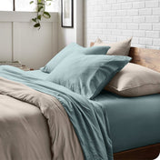 Modern bedroom with washed sheets and duvet cover on a bed