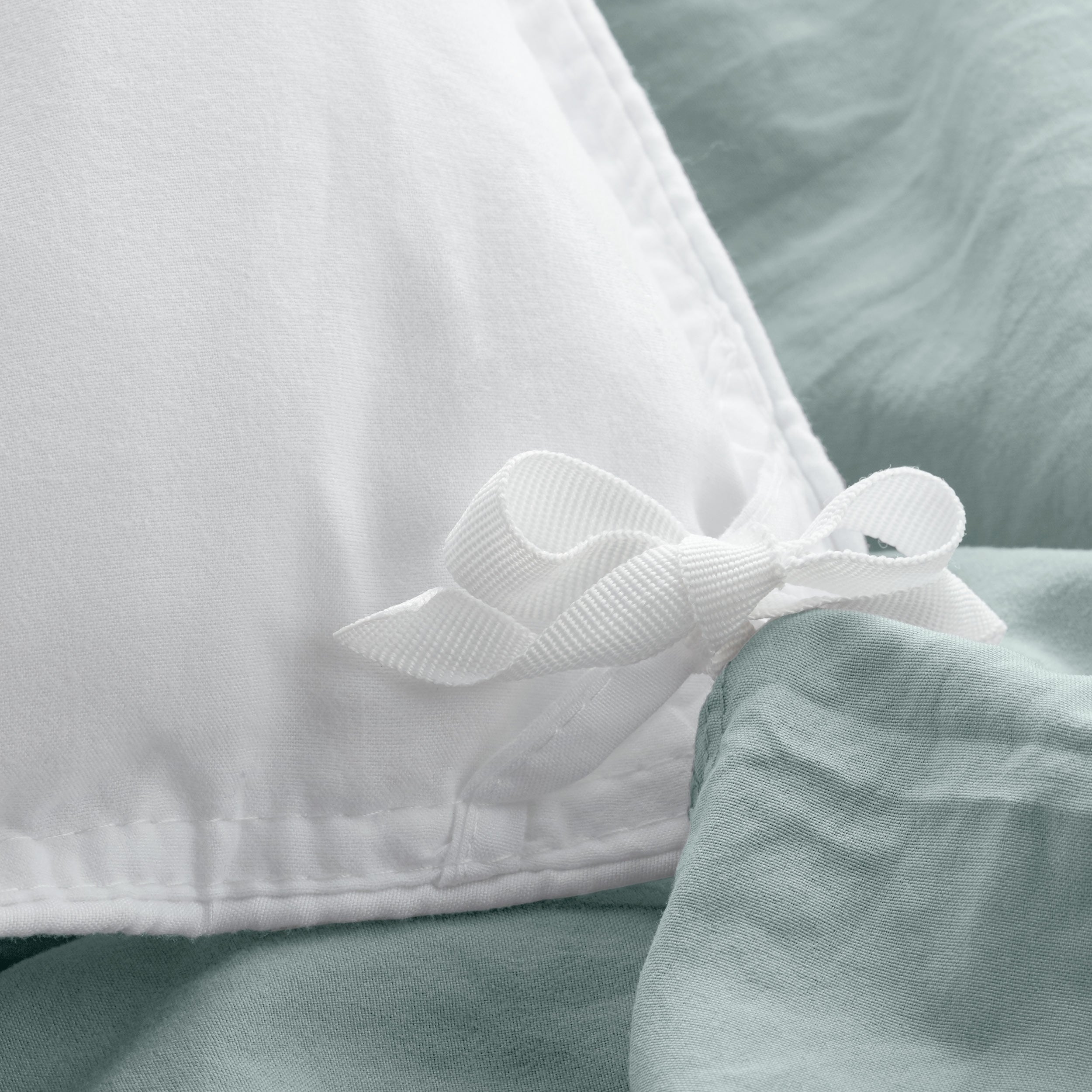 Close up of the corner ties on a duvet cover for attaching a duvet insert