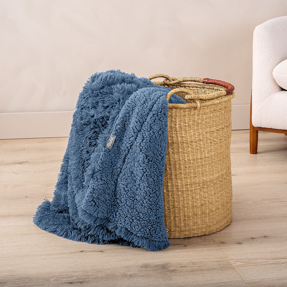 Shaggy Shearling Blue Blanket in a wicket basket