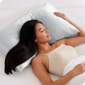 A woman sleeping with her head on a silk pillowcase