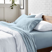 Modern bedroom with washed sheets and duvet cover on a bed