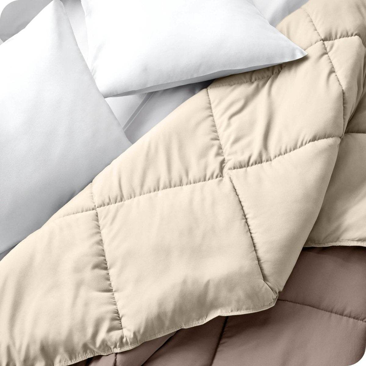 Close up of a comforter folded back to show the different colored sides