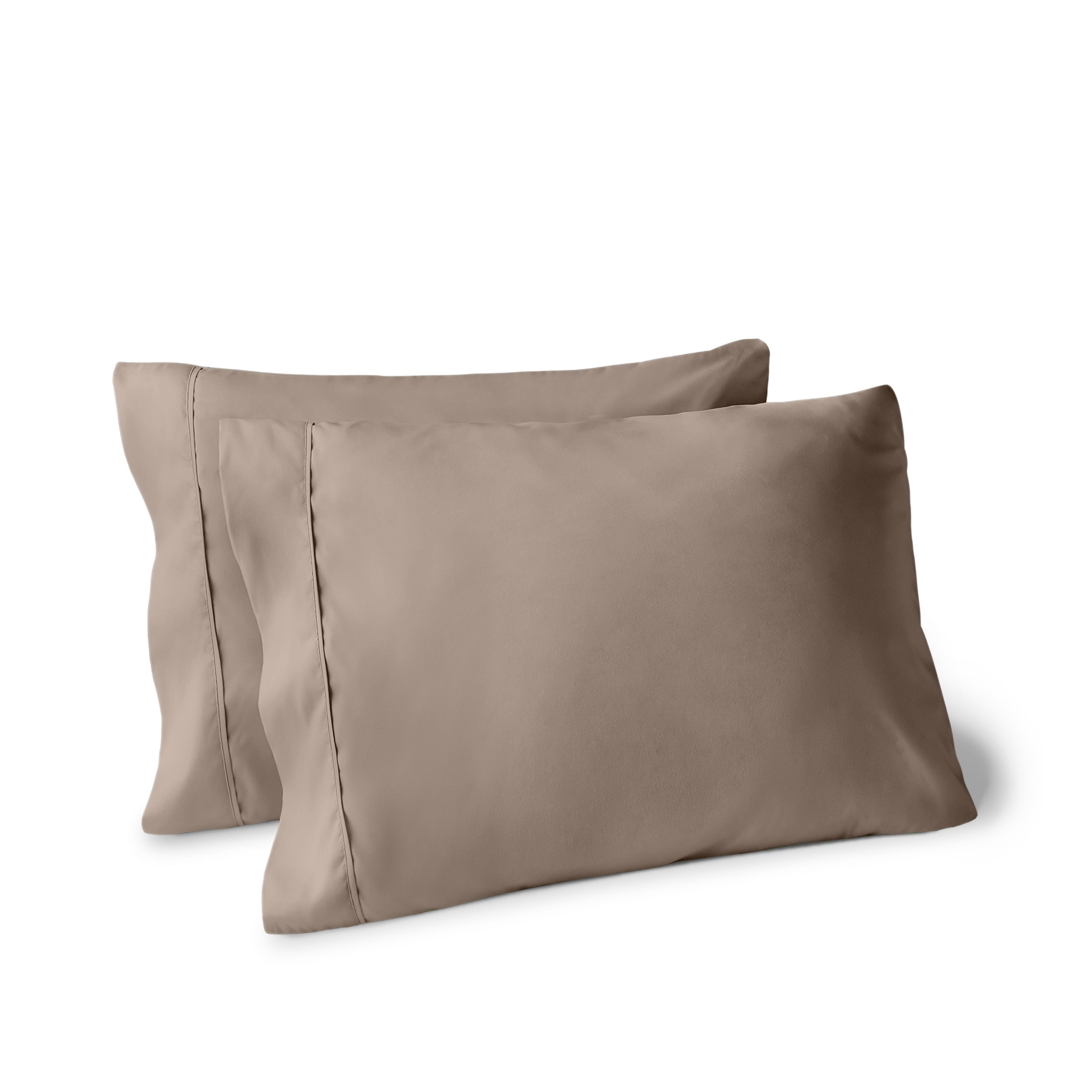 Two pillows on a white background with pillowcases on them