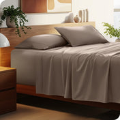 Bed with microfiber bedding and wooden headboard in a bedroom setting