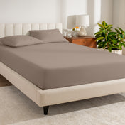 A bed made with a percale fitted sheet