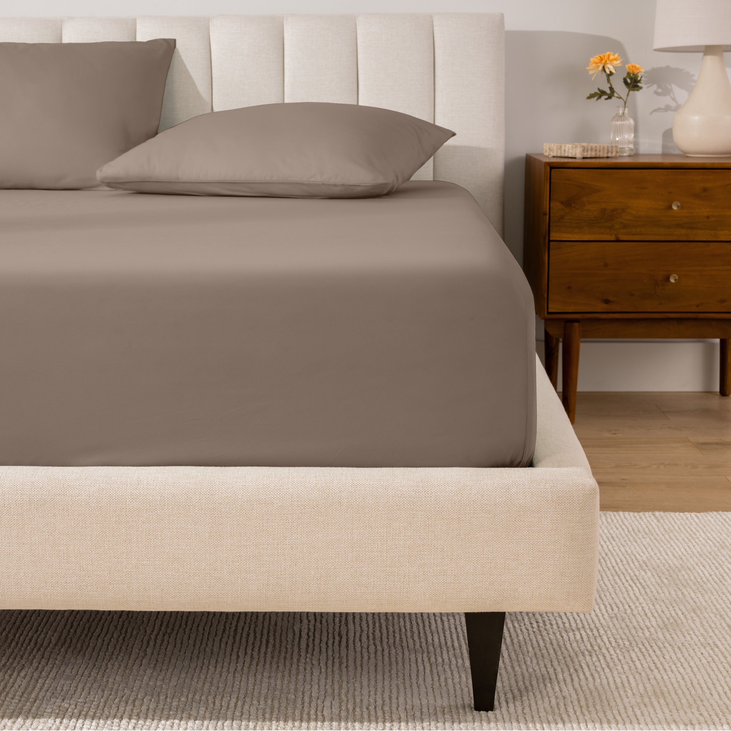 A mattress with a percale fitted sheet on it