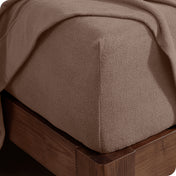 Fitted sheet on a wooden bed frame