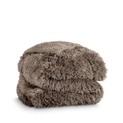 A shaggy faux fur blanket folded
