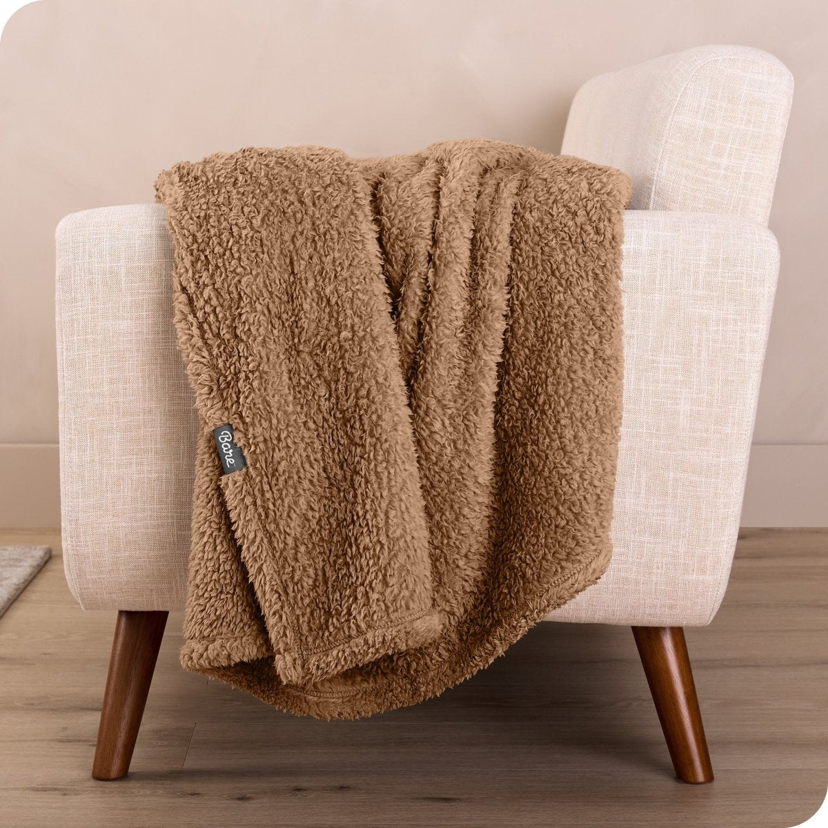 A sherpa blanket draped over a chair