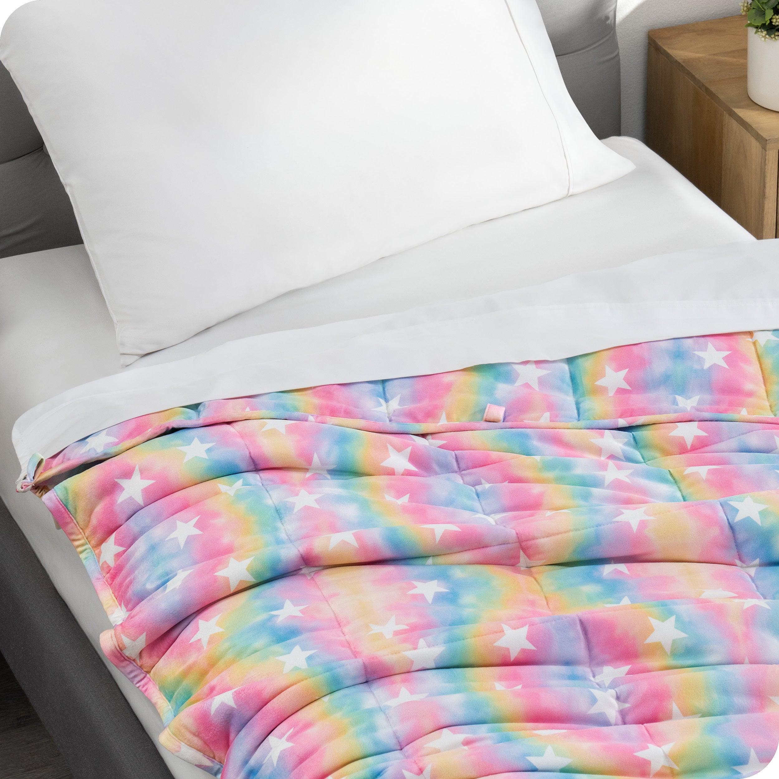 A weighted blanket laid out on a bed.