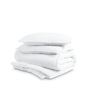 Washed duvet cover and sham set folded and stacked on a white background