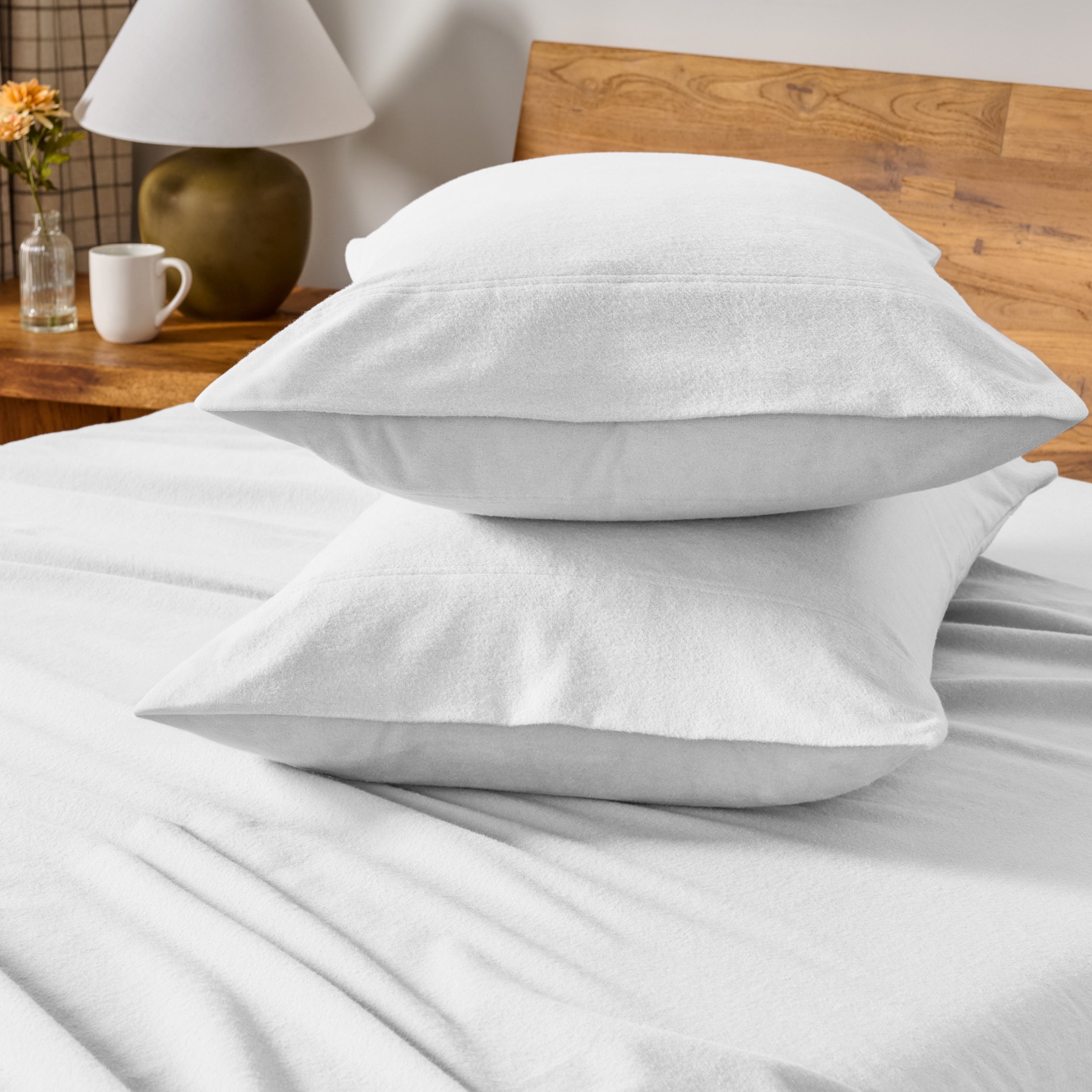 Flannel bedding set on a bed with a beige headboard and lamp.