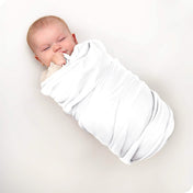 A baby swaddled in a receiving blanket