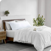 A body pillowcase on a pillow on a bed in a modern bedroom