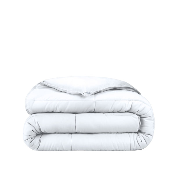 Folded white comforter on a white background