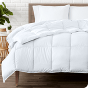 A modern bedroom with a duvet insert on a bed folded back over itself