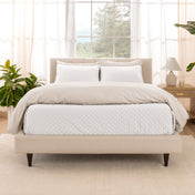 A bright bedroom with a coverlet set on the bed