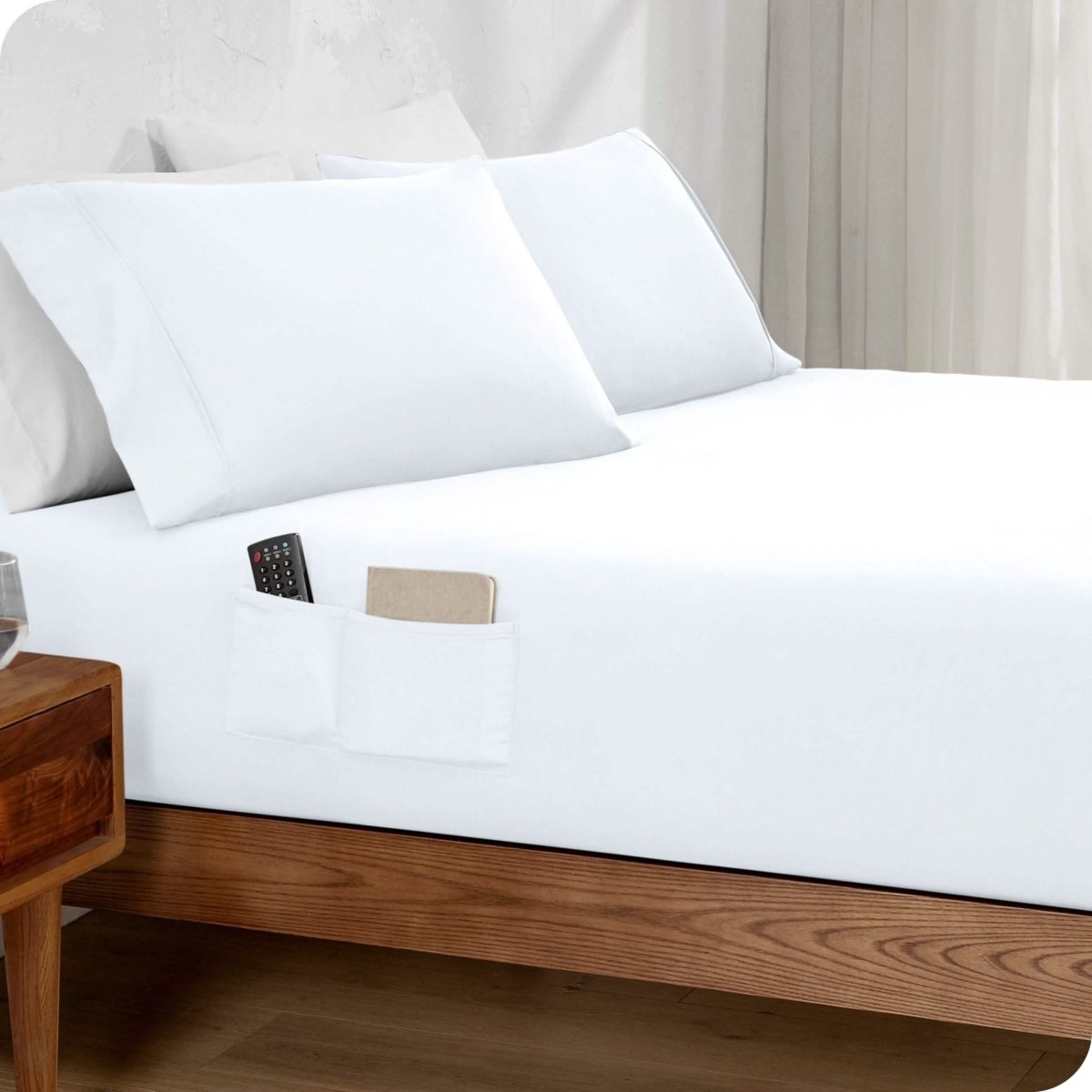 Bed made with a fitted sheet which has pockets on the side
