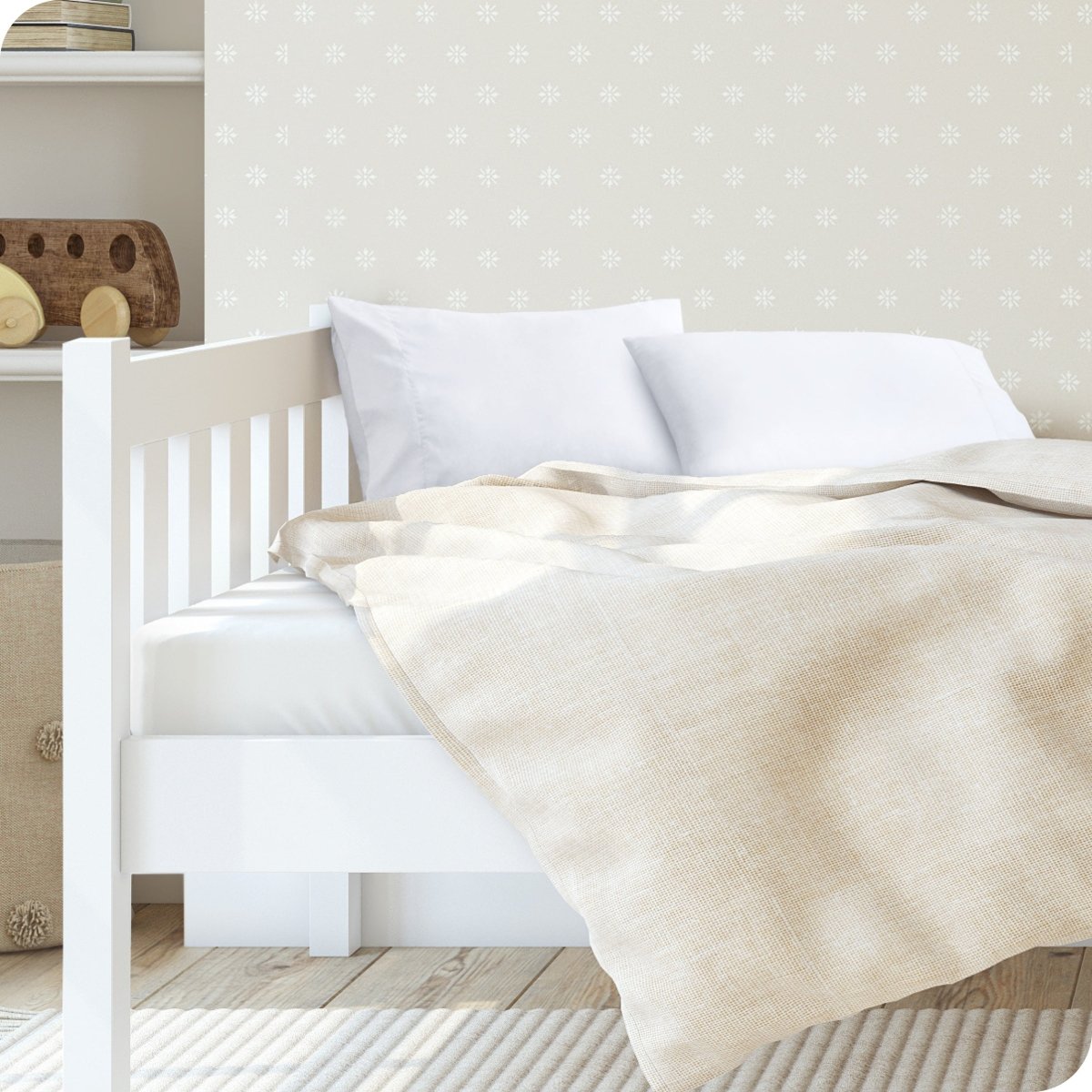 A toddler's bed with 2 microfiber pillowcases on pillows
