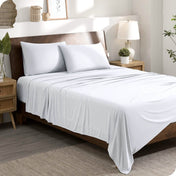 A modern bedroom set with a white sheet set on the bed