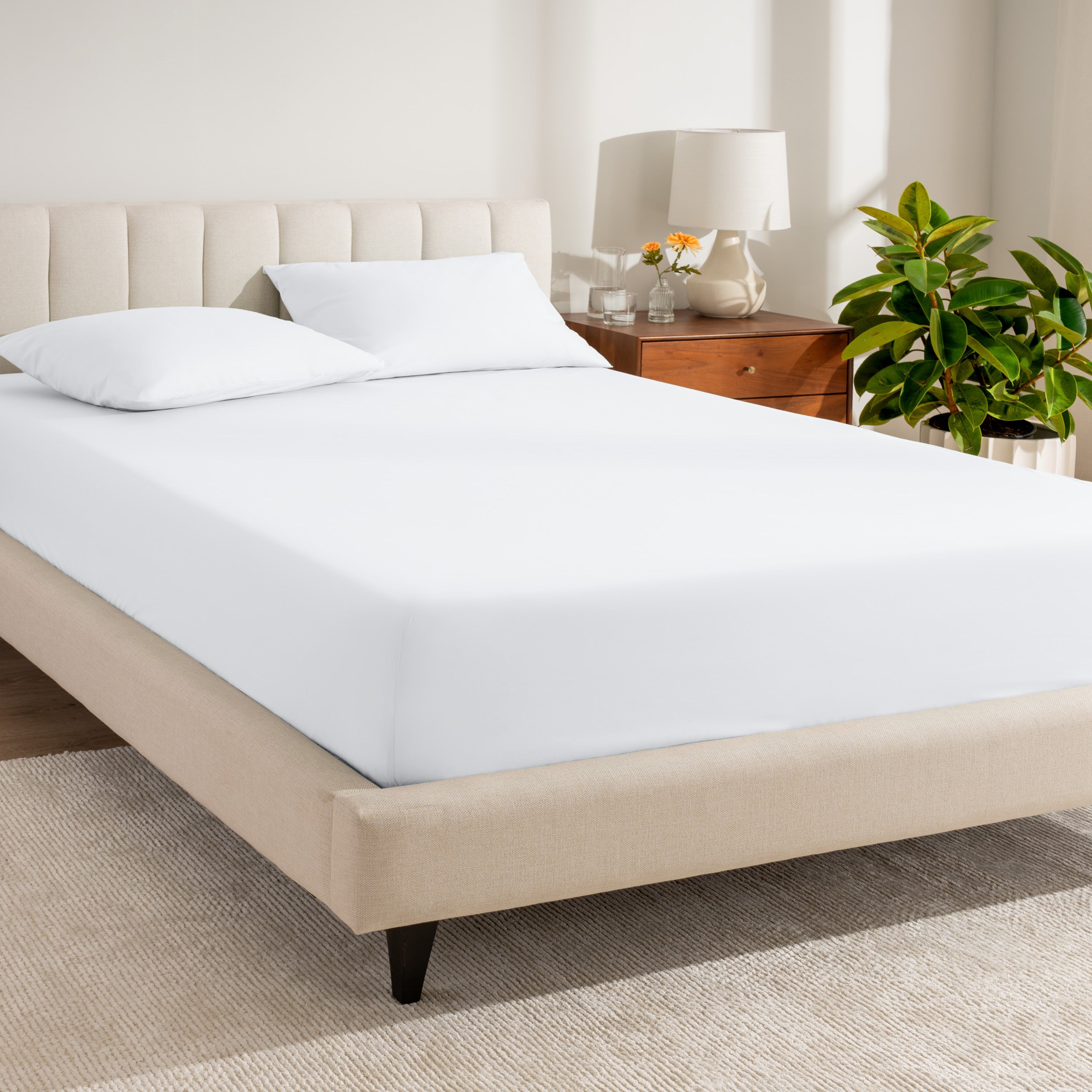 A bed made with a percale fitted sheet