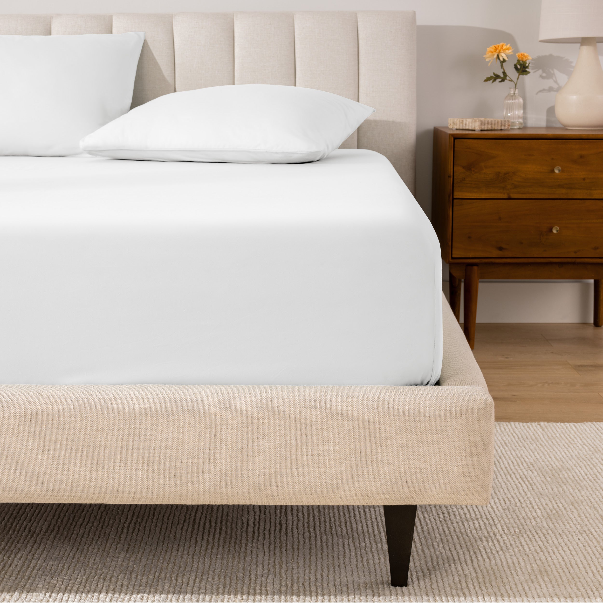 A mattress with a percale fitted sheet on it