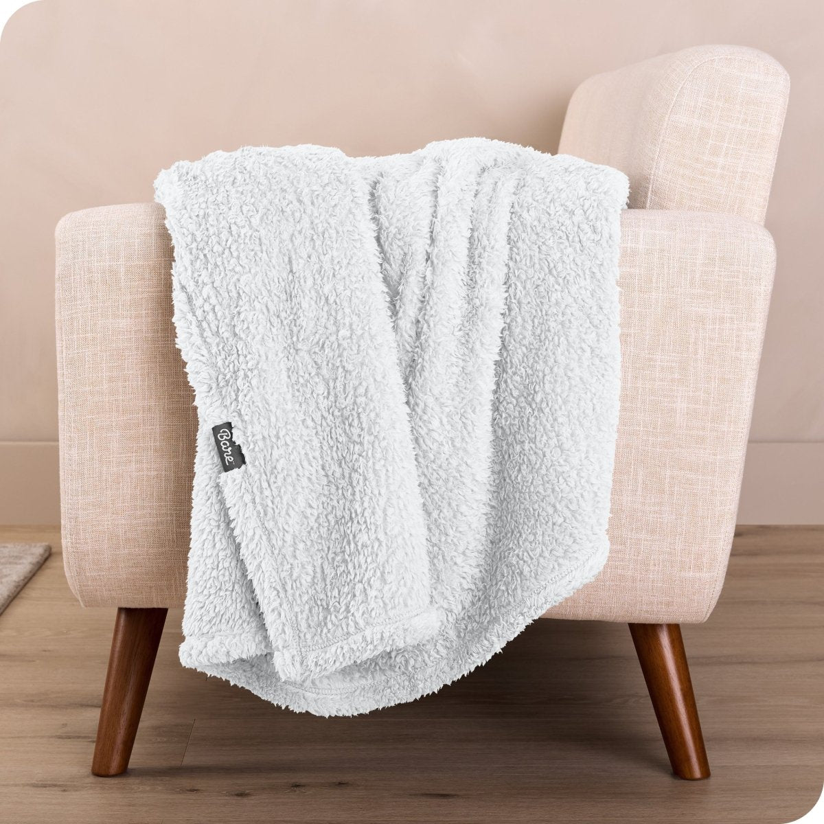 A sherpa blanket draped over a chair