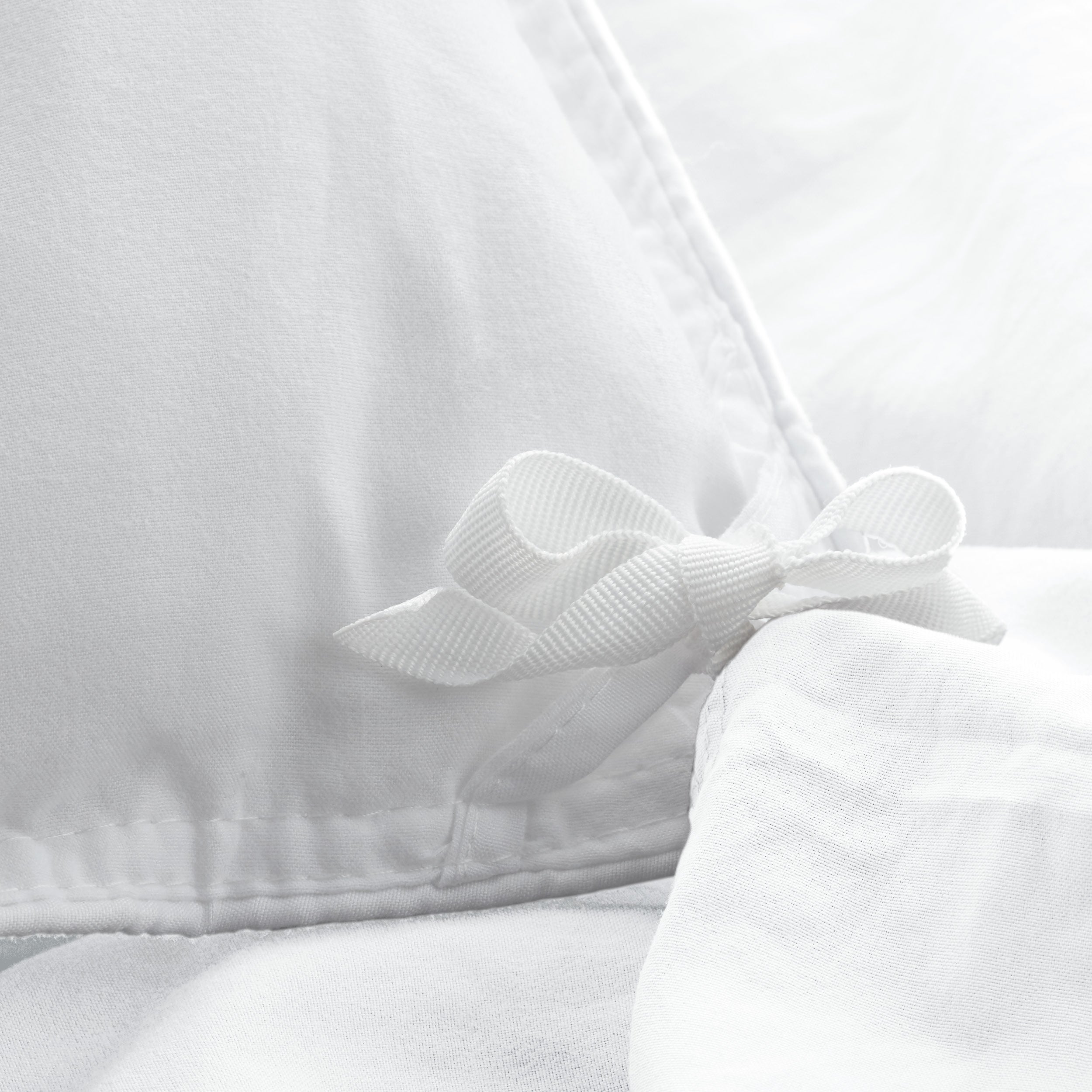 Close up of the corner ties on a duvet cover for attaching a duvet insert