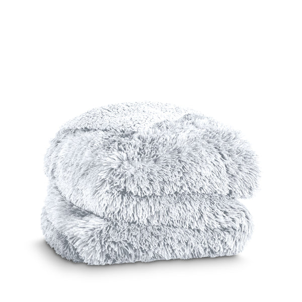 A shaggy faux fur blanket folded