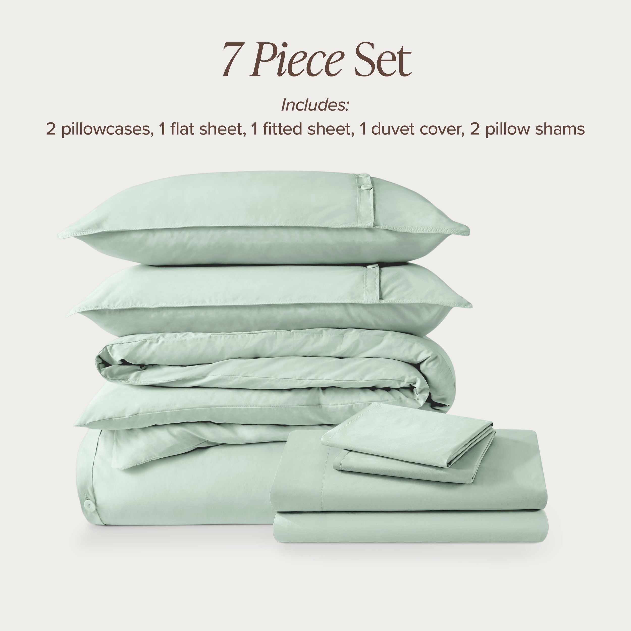 7-piece percale bedding set with pillowcases, flat sheet, fitted sheet, duvet cover, and pillow shams on a light background.