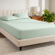 A bed made with a percale fitted sheet