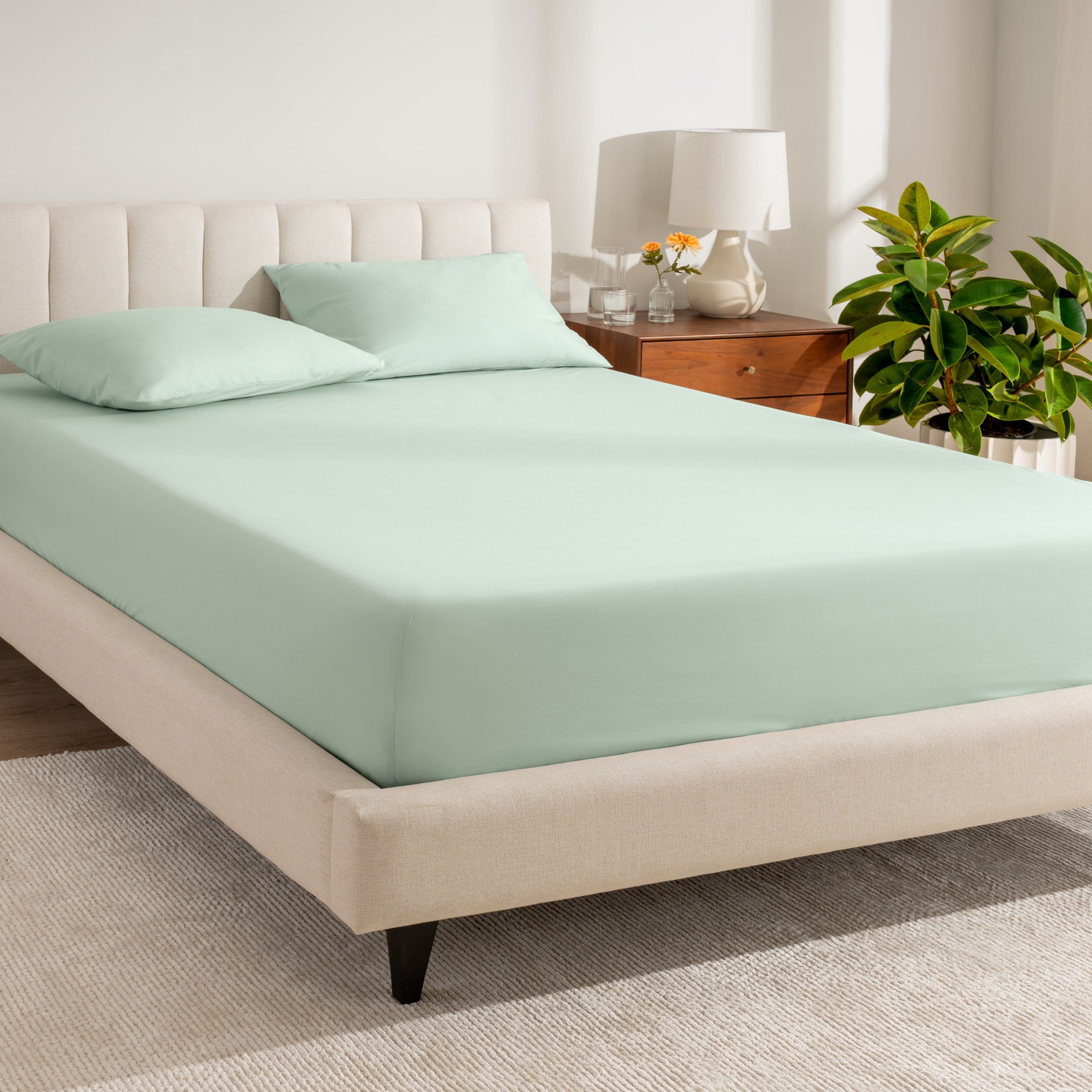A bed made with a percale fitted sheet