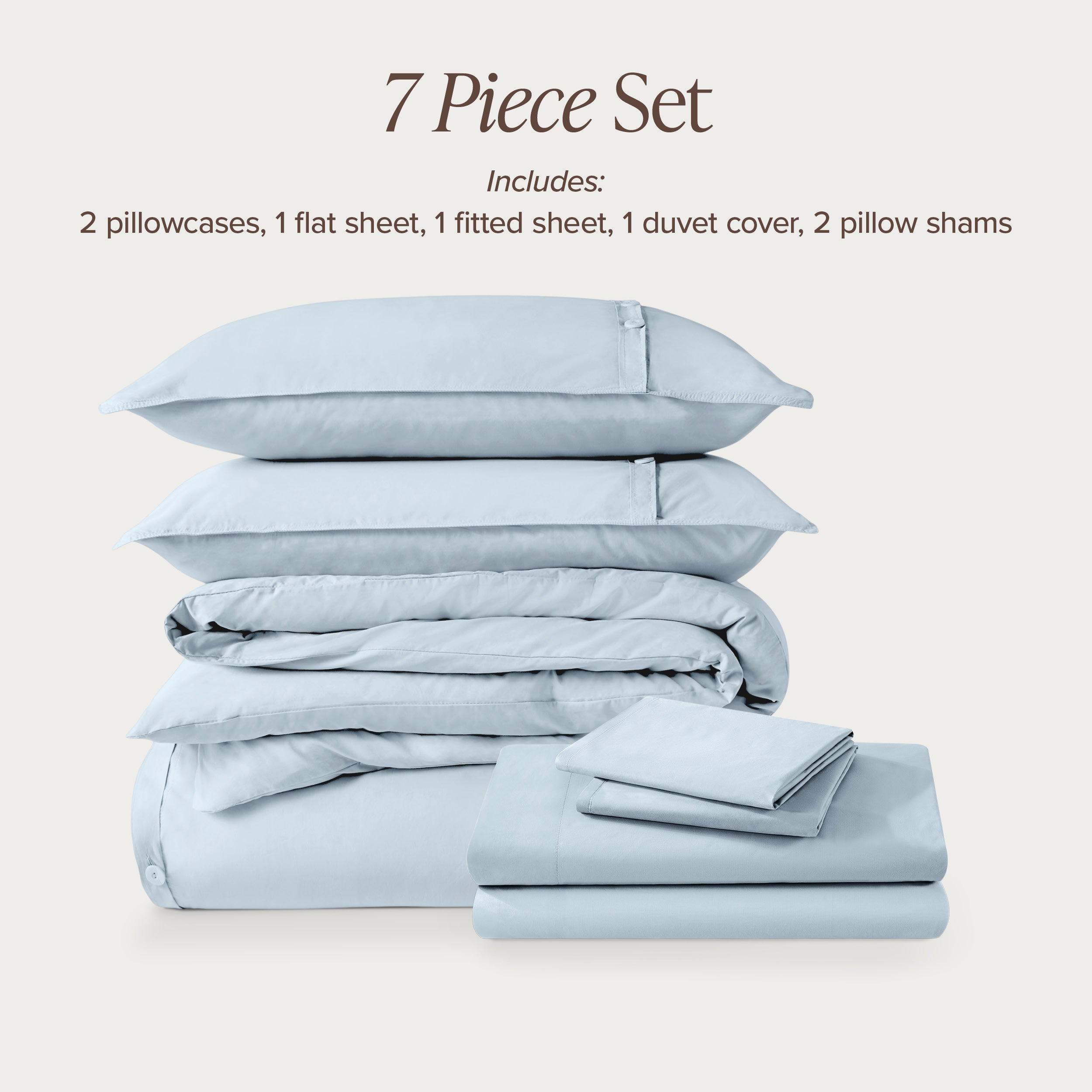 7-piece percale bedding set with pillowcases, flat sheet, fitted sheet, duvet cover, and pillow shams on a light background.