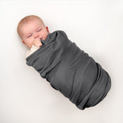 Baby wrapped in flannel receiving blanket