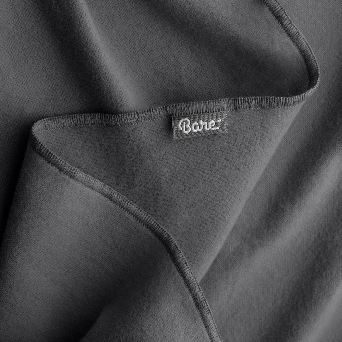 Up close image flannel receiving blanket showing tag