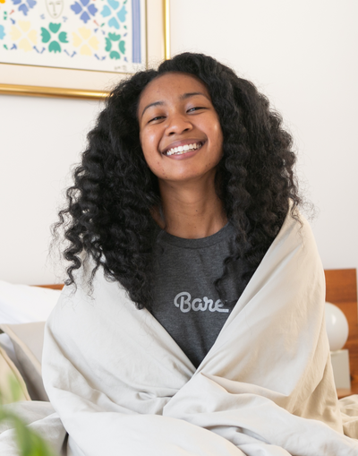 Woman smiling wrapped in a blanket, influencer photo