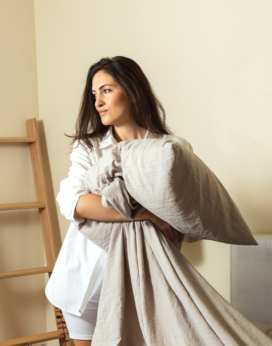 Woman in a cream outfit standing, influencer photo