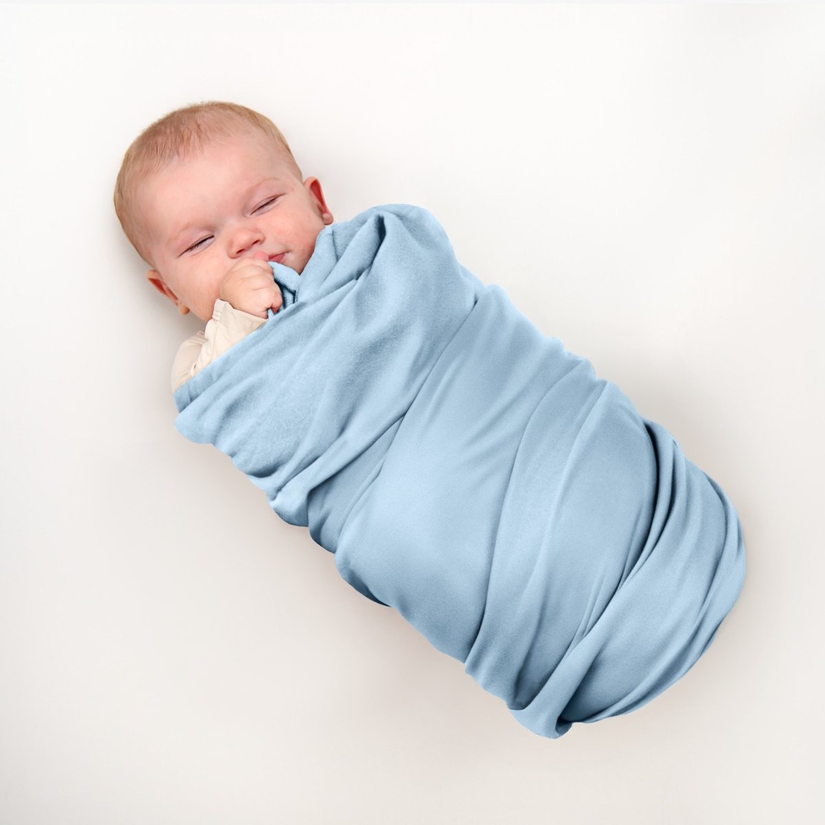 Baby wrapped in flannel receiving blanket