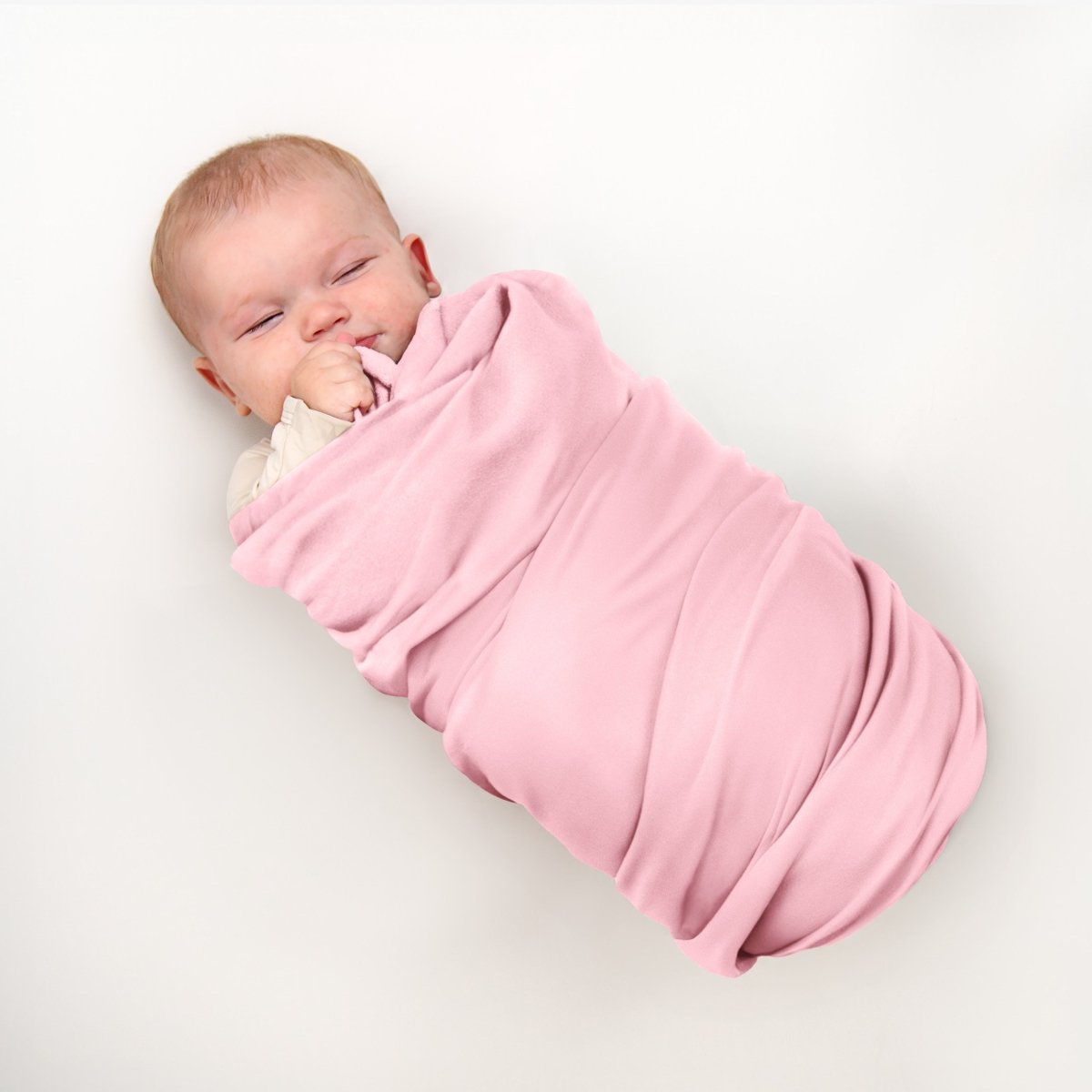 Baby wrapped in flannel receiving blanket